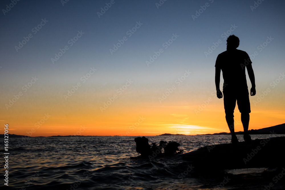 Silhouette of man enjoying sunset