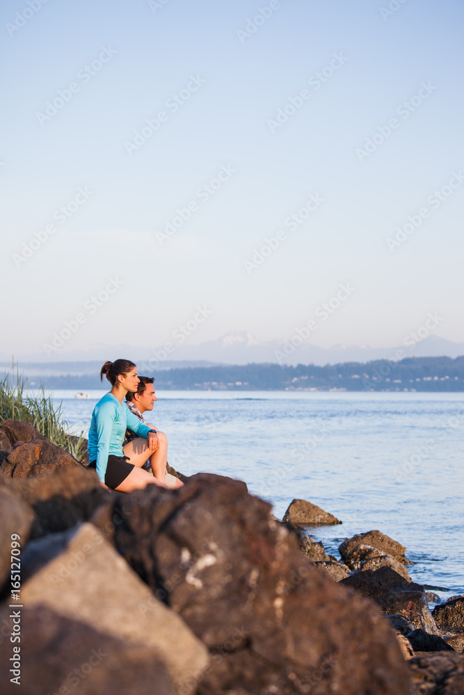 Couple sitting on the beach enjoying the scenery Couple sitting on the beach enjoying the scenery