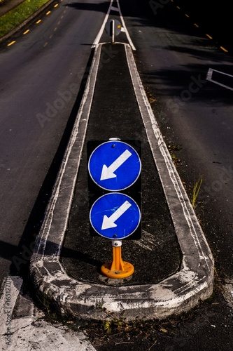 Sign: Two blue keep left arrows