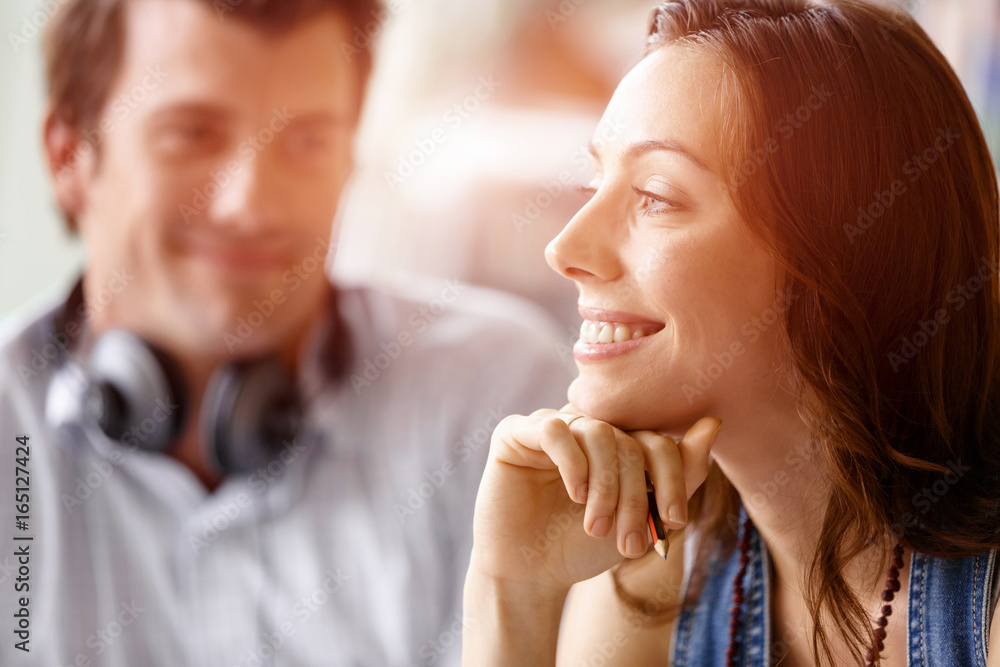 Young pretty woman smiling with man on background Young pretty woman smiling with man on background