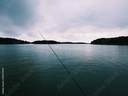 Fishing rod on calm sea view 