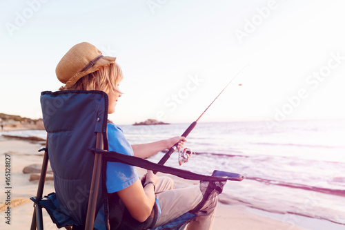 Teenage boy fishing at sea