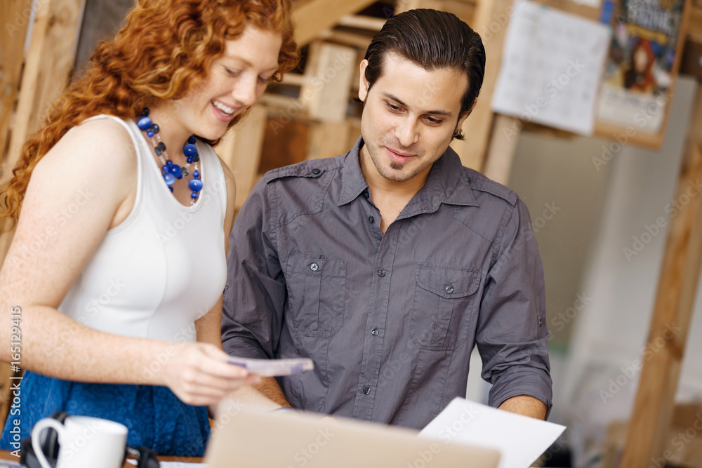 Two young people in office