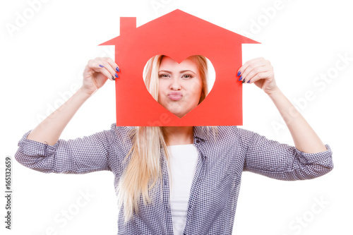 Happy woman holding red paper house