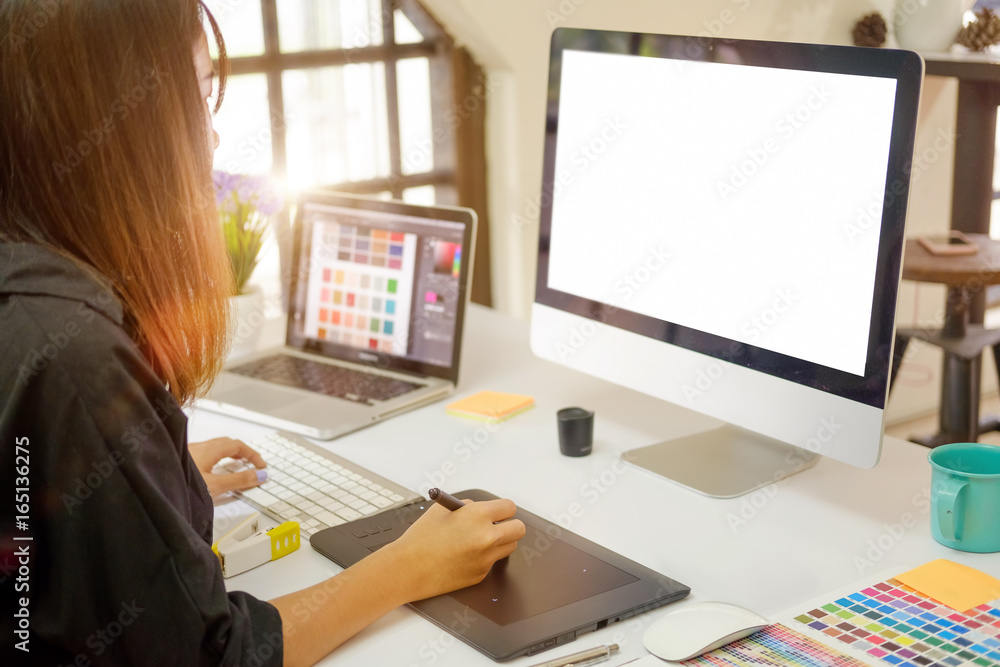Young photographer and graphic designer at work in studio office. Young photographer and graphic designer at work in studio office.