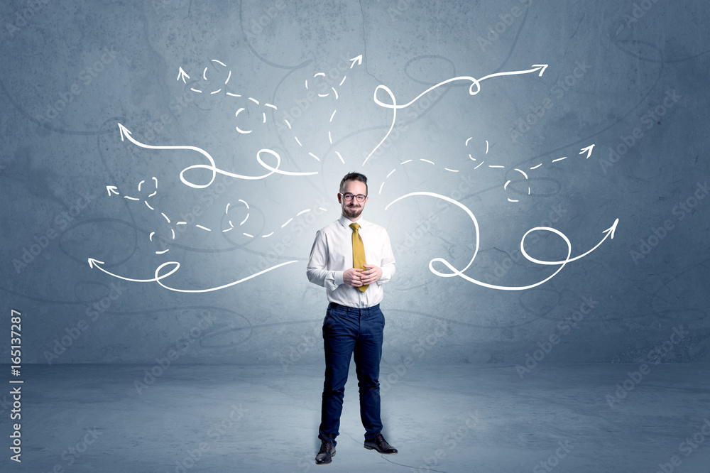 Businessman standing with winding arrows around Businessman standing with winding arrows around