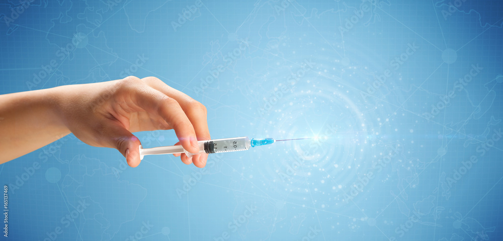 Female doctor holding syringe Female doctor holding syringe