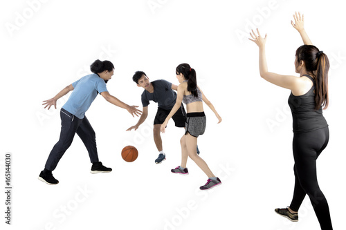 Multiracial people playing basketball
