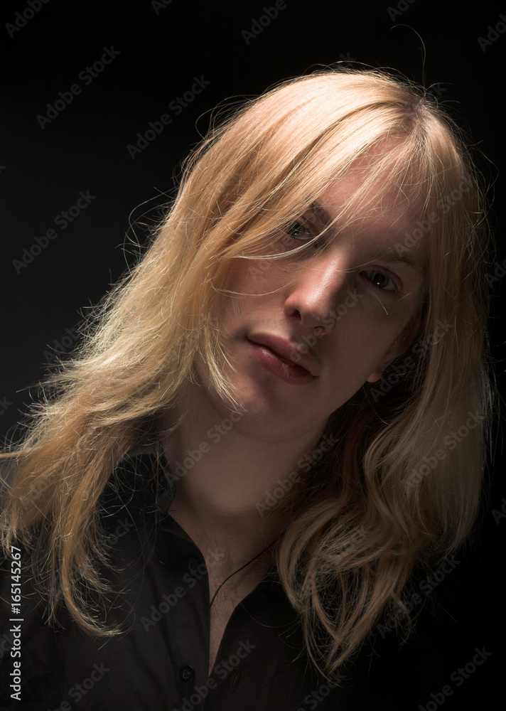 Young man with long blond hair Young man with long blond hair