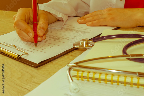 Doctor working in hospital writing a prescription. Medicine doct photo