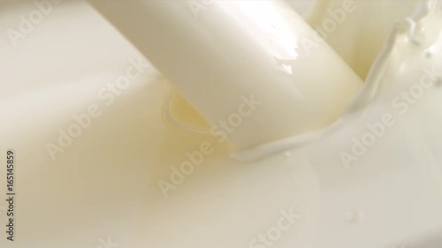 Pouring Milk closeup. Milk Splesh Slow Motion. photo