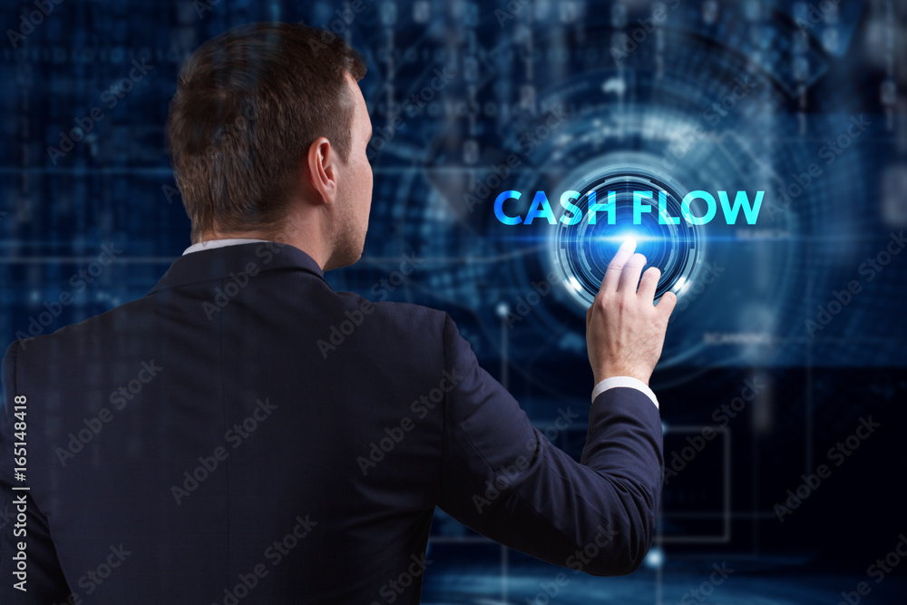 Business, Technology, Internet and network concept. Young businessman working on a virtual screen of the future and sees the inscription: Cash flow Business, Technology, Internet and network concept. Young businessman working on a virtual screen of the future and sees the inscription: Cash flow