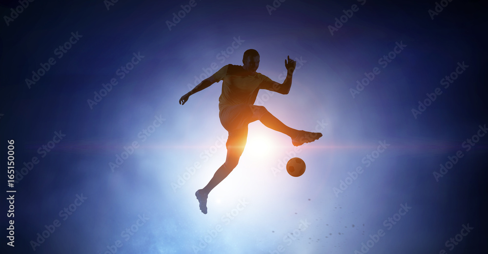 Naklejka premium Soccer player with ball outdoors