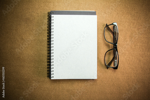 Notebook and glasses with vignette.