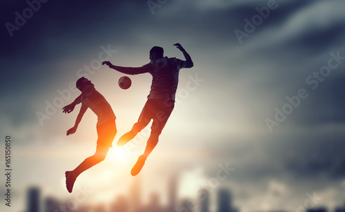 Silhouettes of two soccer players © Sergey Nivens