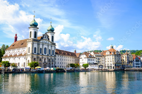 Cityscape of riverside buildings and church in Lucerne, Switzerland.