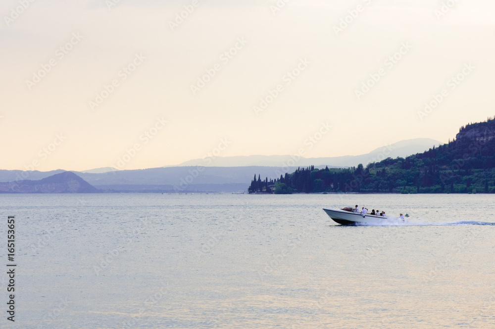 motor boat on a lake at sunrise