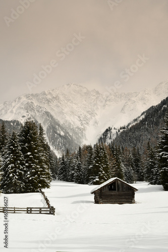 alpine huts in winter in the dolomites. italy
