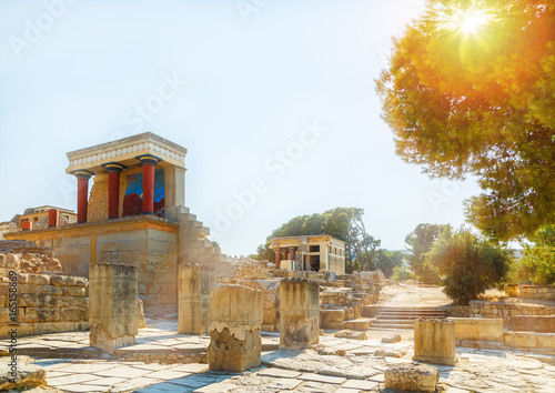 Ruins of the Knossos Palace with the sun filtering through the trees at Crete, Greece photo