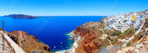 Panorama of bay with port and colorful houses in Oia town, Santorini island