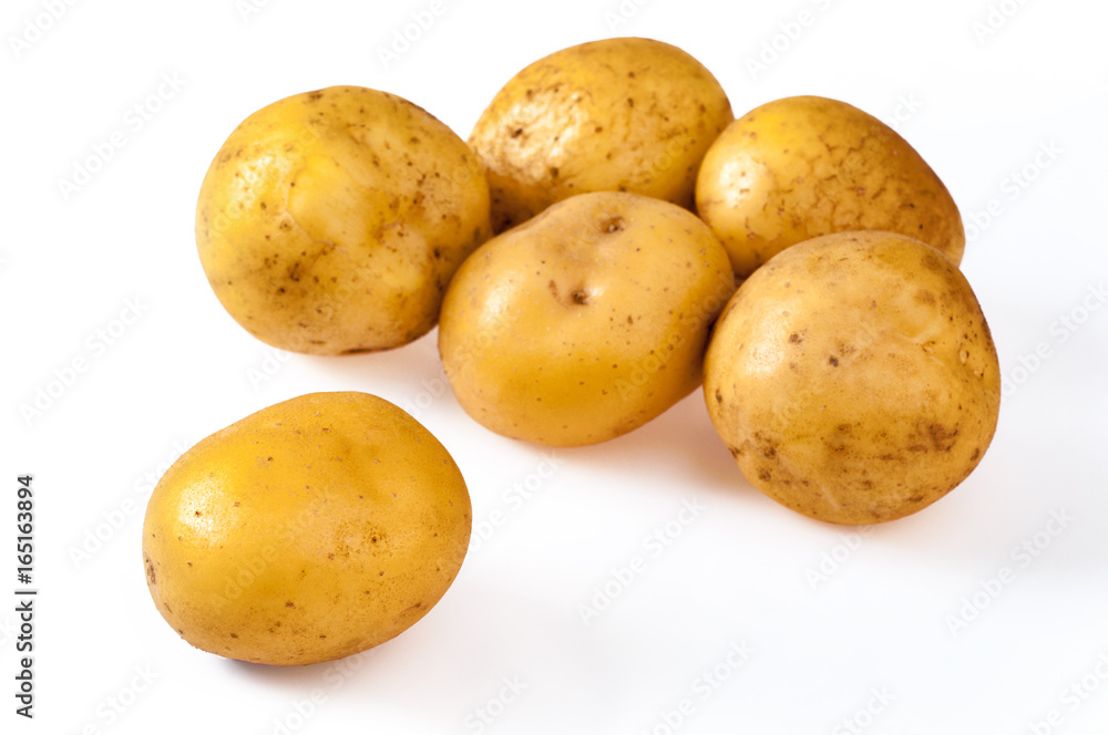 Pile of fresh, yellow, ripe potatoes, isolated on white. Close up Pile of fresh, yellow, ripe potatoes, isolated on white. Close up