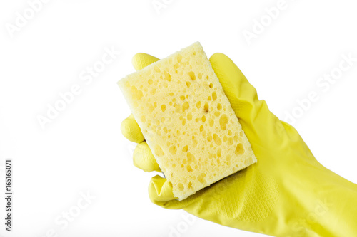 hand in rubber yellow glove holding sponge on white background. cleaning