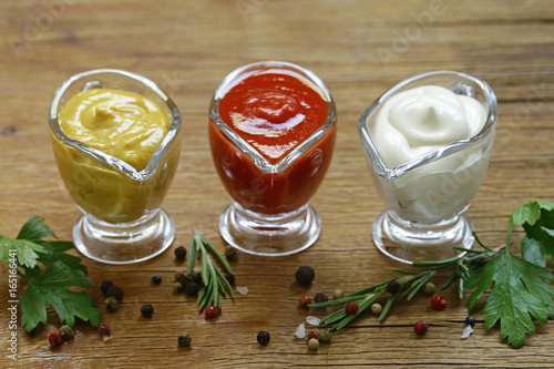 Fotografi Different types of sauces in glass gravies