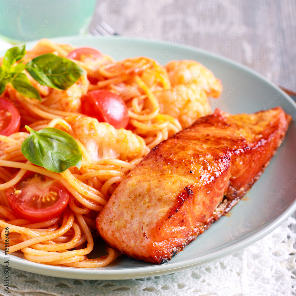 Fried trout fish and spaghetti on plate Fried trout fish and spaghetti on plate