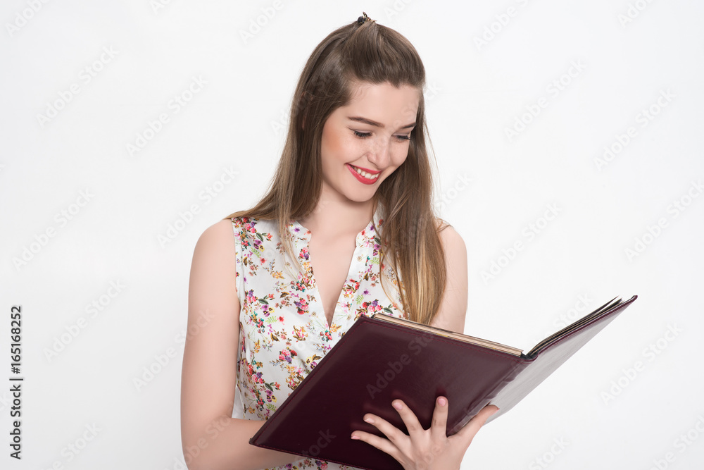 Girl looks at a folder with documents Girl looks at a folder with documents