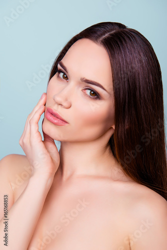 So cute and pure   Close up cropped photo of young charming brunette girl  touching gently her shining healthy skin