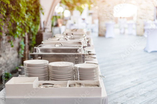 Buffet heated trays standing in line ready for service. Outdoors buffet restaurant, the hotel restaurant.