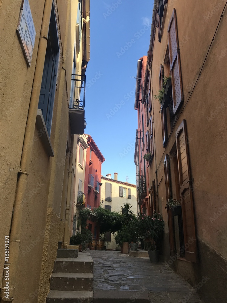 Small colorful alley in a town, south of France