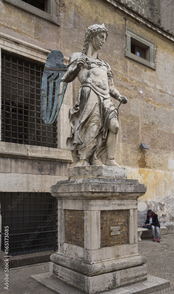 Old statue of Michael the Archangel in yard of Castle Saint Ange