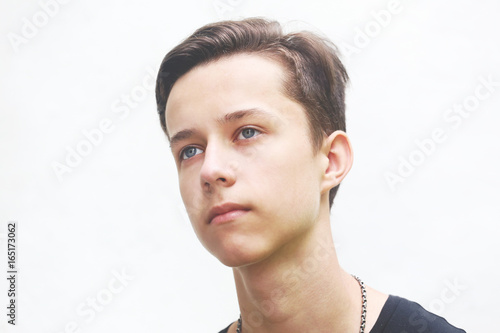 Young man profile face on grey