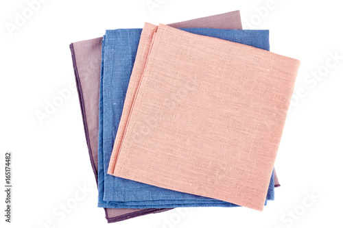 Stack of three colorful textile napkins on white