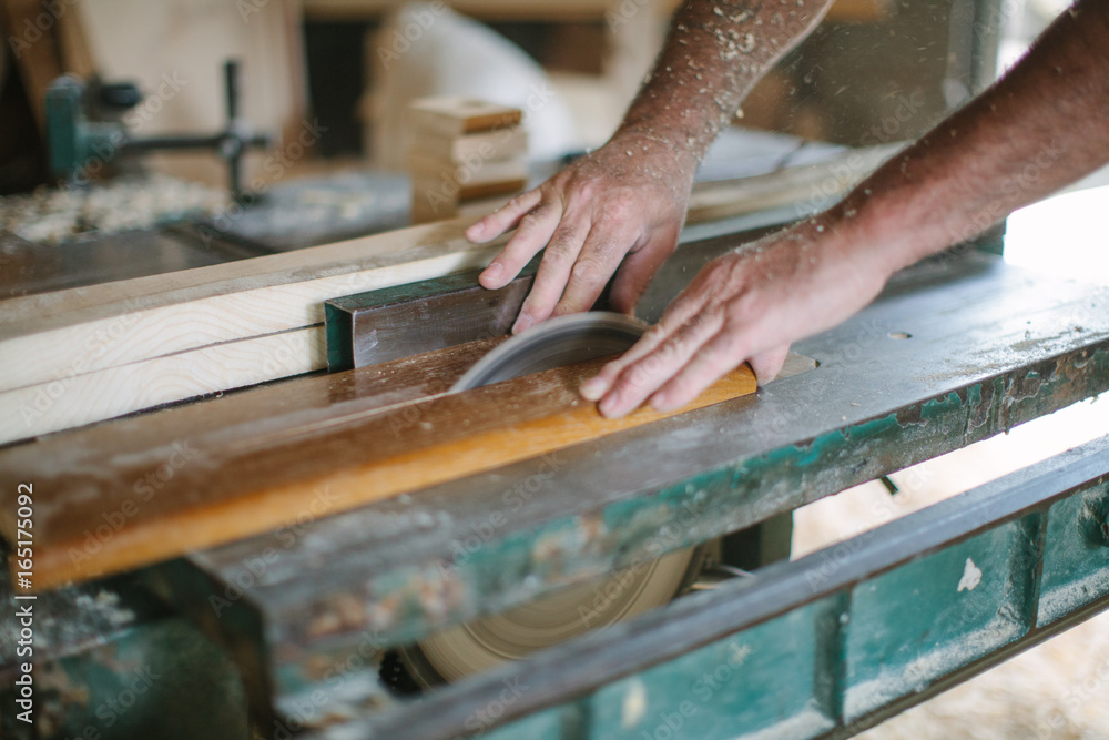 Carpenter Sawing a Board Carpenter Sawing a Board
