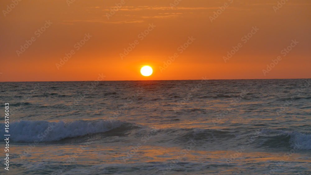 The sun rises over the sea