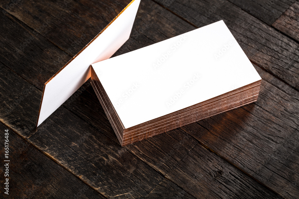 blank business cards with golden hot stamping edges on wooden background blank business cards with golden hot stamping edges on wooden background