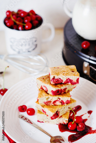 Cake, dessert and pastries, biscuit pie with cherry, raspberries and milk on a light background 