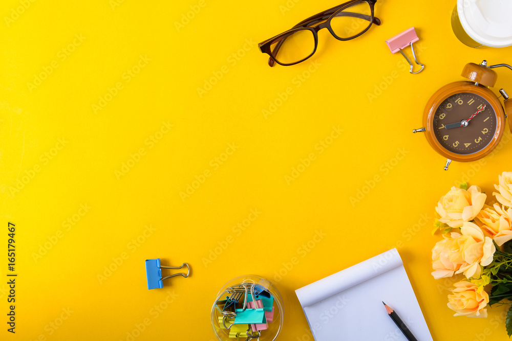Office equipment on a yellow and golden paper desk Office equipment on a yellow and golden paper desk