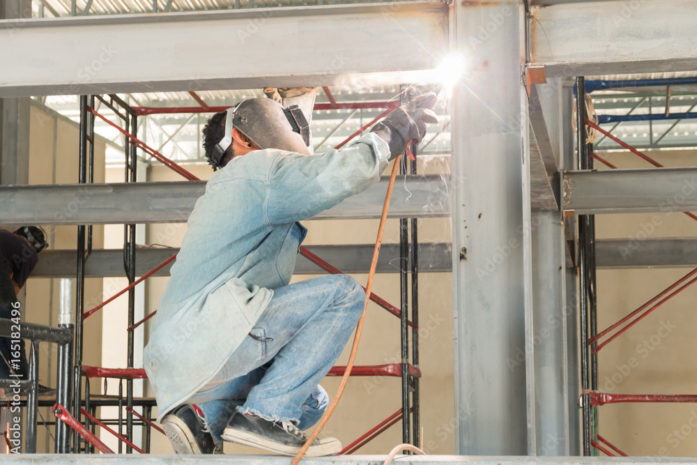 Man weld a metal with a welding machine. Man weld a metal with a welding machine.