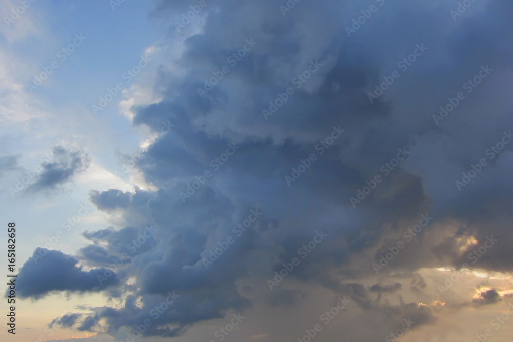 Big high cumulus cloud on the blue sky on sunset or sunrise