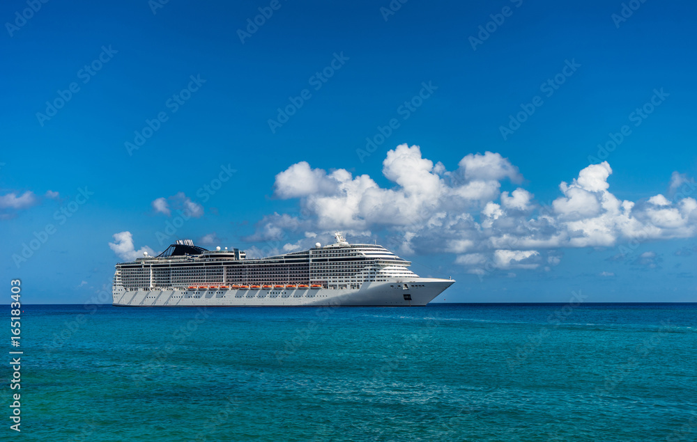 Cruise ship in crystal blue water with a pirate and pirate flag on the front