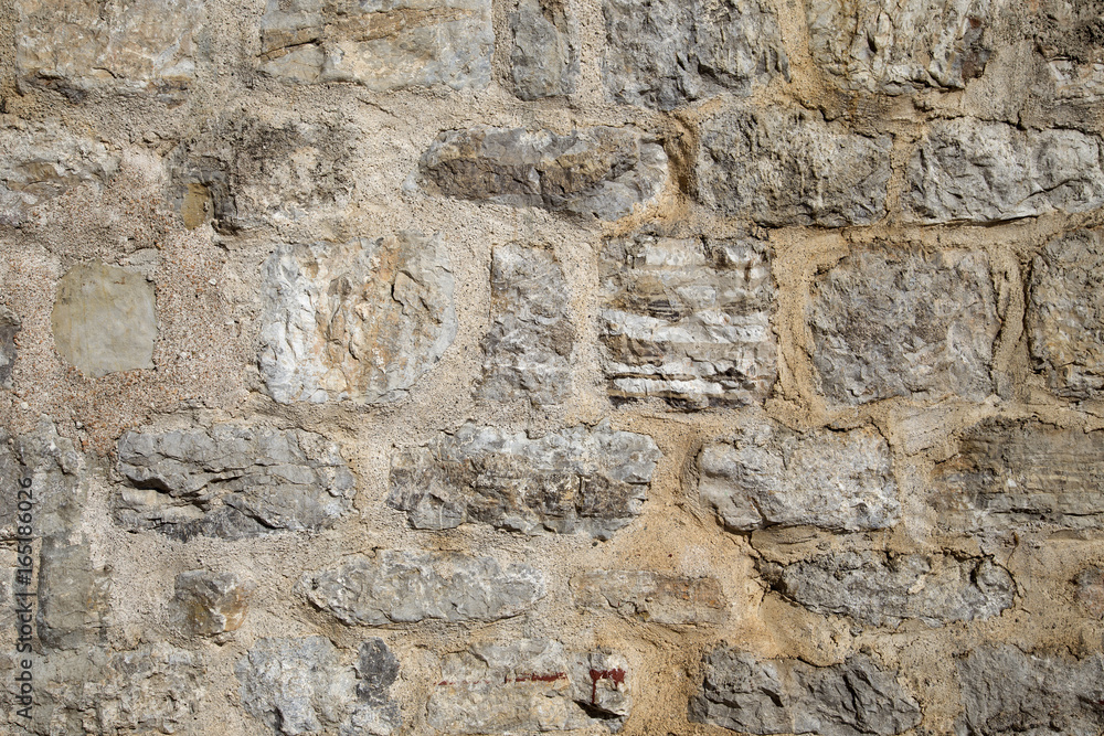 Pattern of the ancient style stone wall with cement.