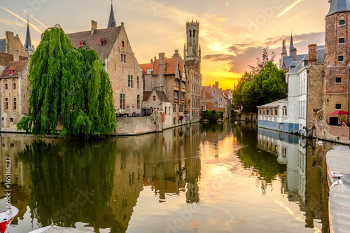 Bruges (Brugge) cityscape with water canal at sunset photo