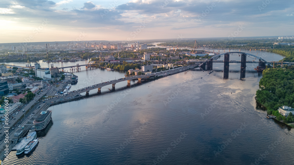 Aerial top view of Dnepr river and Rybalskiy island from above, bridges of Kiev city, Ukraine
