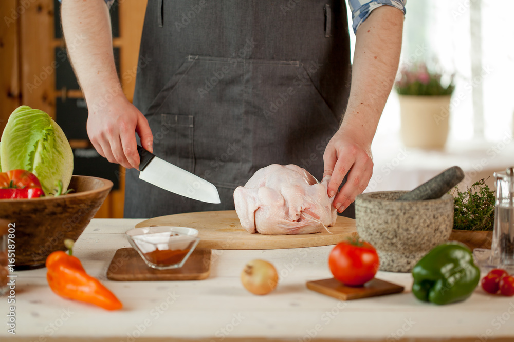 male preparing chicken for cooking male preparing chicken for cooking