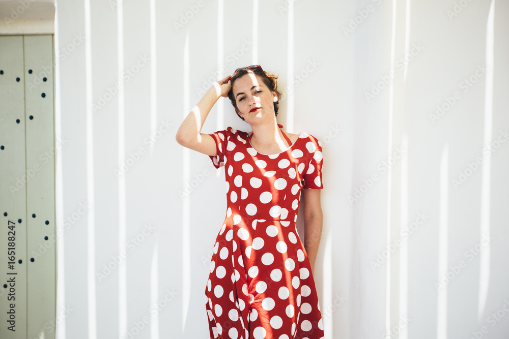 Young woman dressed with red dress with polka dots Young woman dressed with red dress with polka dots