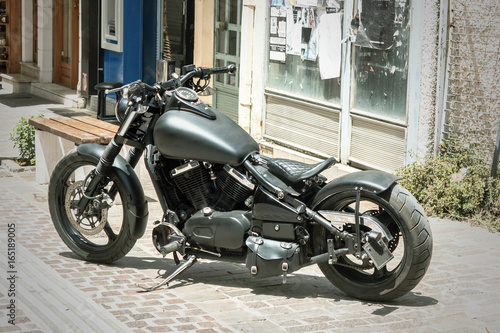 Black motorbike on the pavement photo