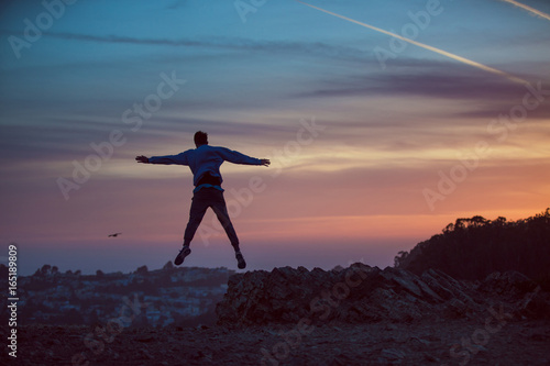 Man jumping into sunset